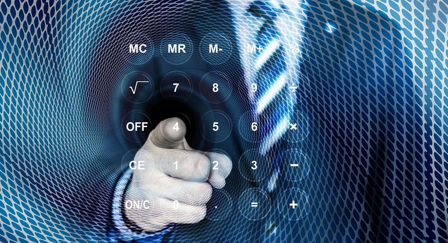 Digital image of a man pointing at  calculator icons on a screen